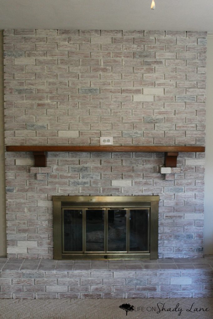 How to Whitewash a Brick Fireplace via Life on Shady Lane blog || Kansas City life, home, and style blogger Megan Wilson shares a step by step fireplace makeover guide! || www.lifeonshadylane.com 