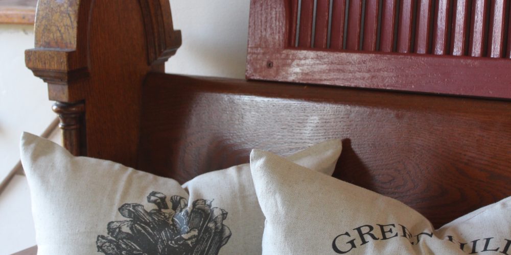 Antique church pew and christmas pillows via Life on Shady Lane blog