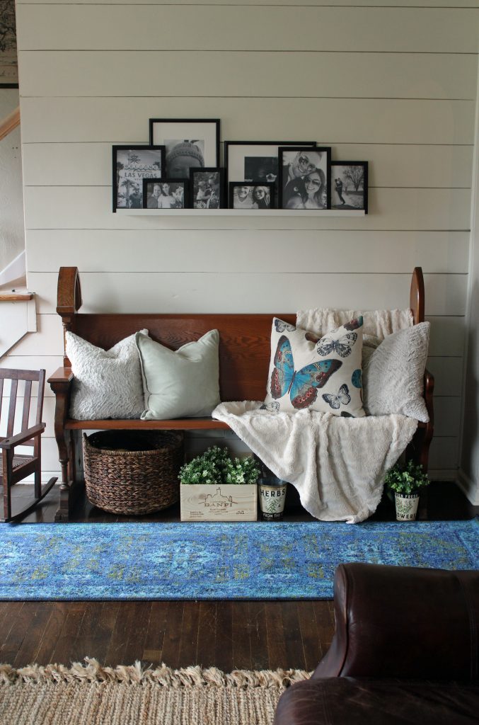 Blue runner rug, shiplap wall, black and white family photos | A pop of blue, modern farmhouse entryway via Life on Shady Lane blog 