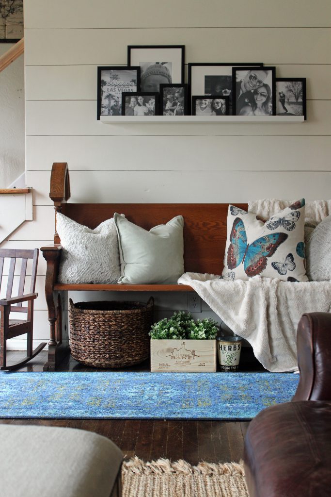 Blue runner rug, shiplap wall, black and white family photos | A pop of blue, modern farmhouse entryway via Life on Shady Lane blog 