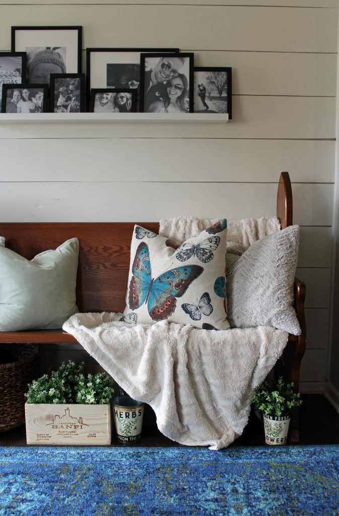 Blue runner rug, shiplap wall, black and white family photos | A pop of blue, modern farmhouse entryway via Life on Shady Lane blog 