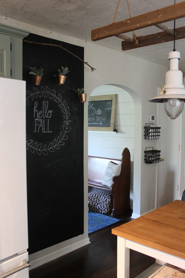 Chalkboard wall with hanging copper planters - perfect for turning a big, blank kitchen wall into something that is stylish, fun, and functional! 