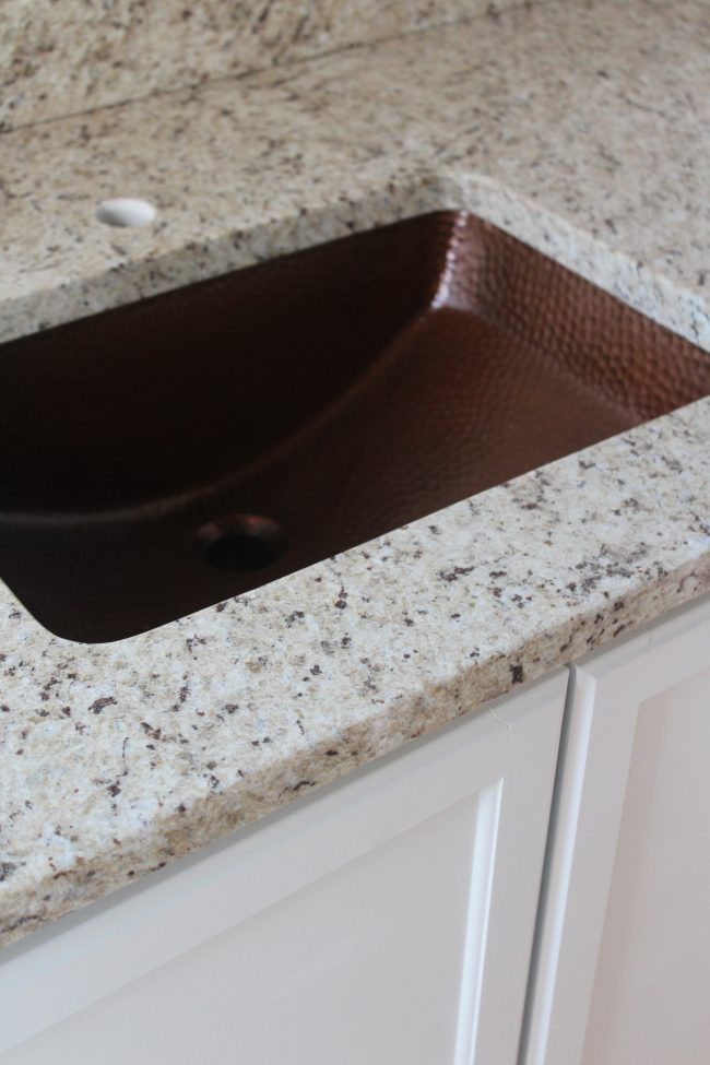 Modern farmhouse bathroom remodel: copper sink and granite countertops