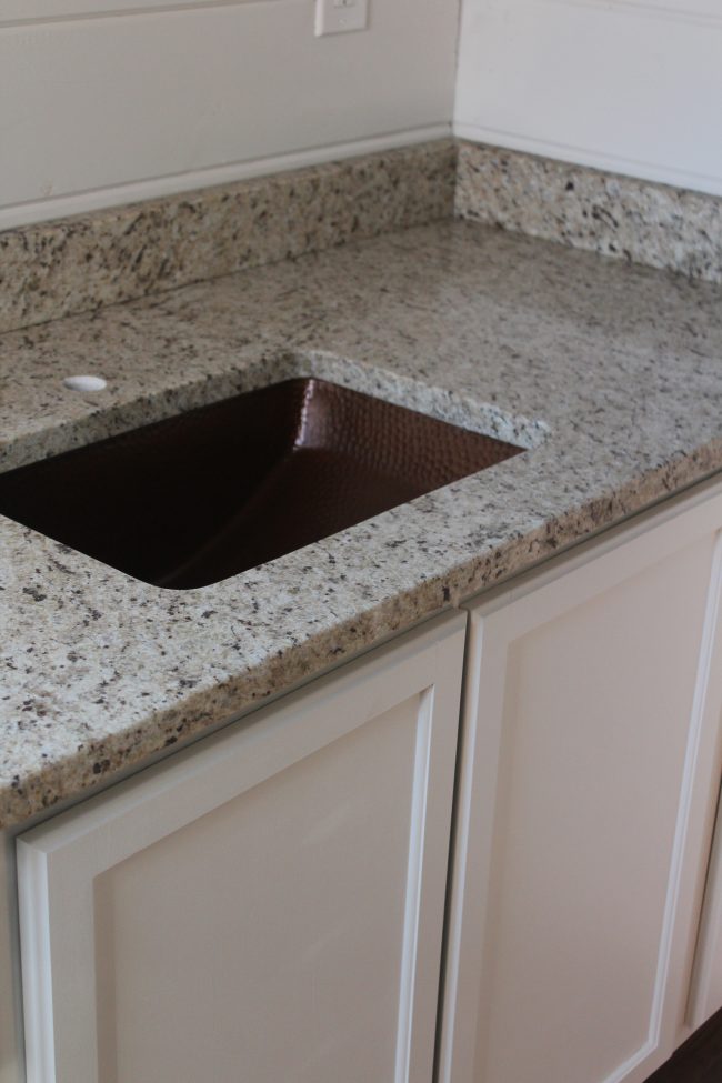 Modern farmhouse bathroom remodel: copper sink and granite countertops