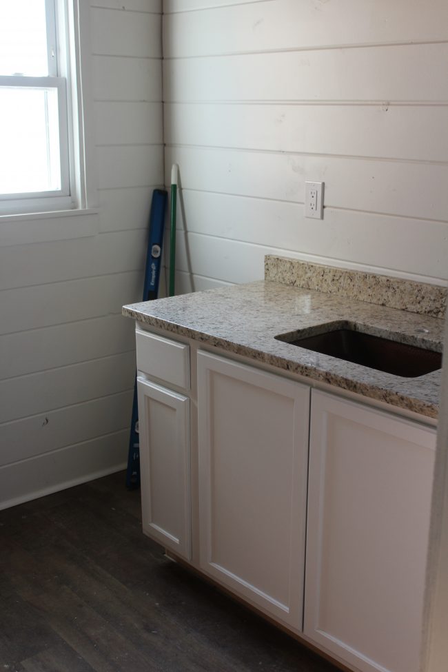 Modern farmhouse bathroom remodel: copper sink and granite countertops