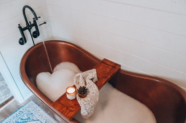 A DIY tub tray makes your bathroom feel just like a spa, and is perfect for holding all of your bath essentials!