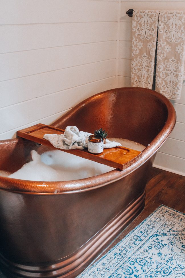 A DIY tub tray makes your bathroom feel just like a spa, and is perfect for holding all of your bath essentials!