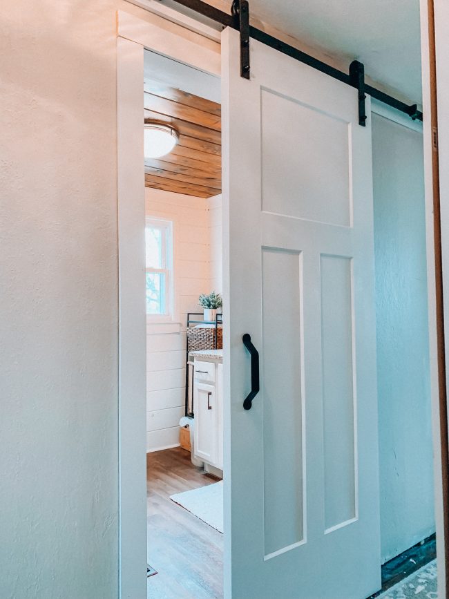 Sliding barn door on a modern farmhouse bathroom || Kansas City life, home, and style blogger Megan Wilson shares an update on her bathroom remodel || Life on Shady Lane blog