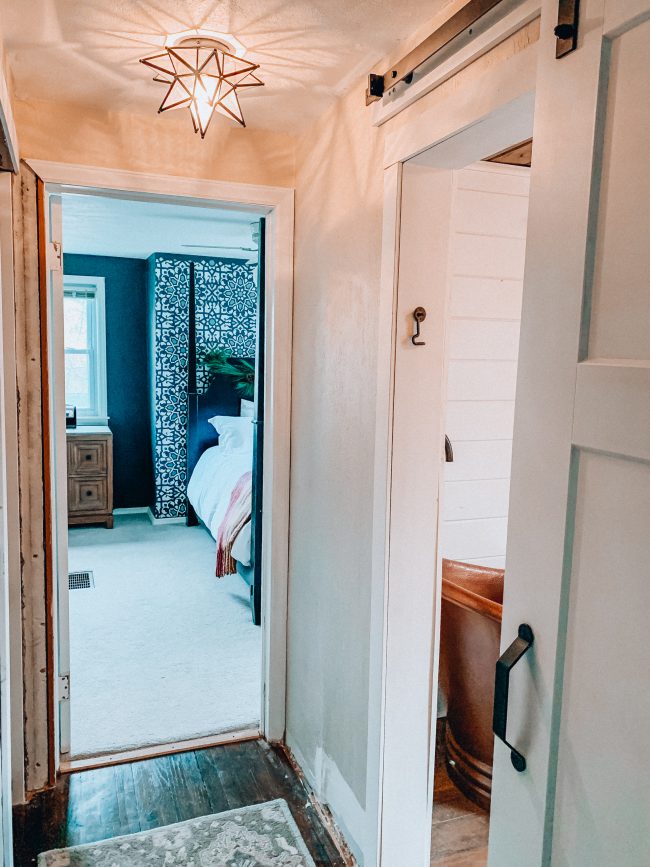 Sliding barn door on a modern farmhouse bathroom || Kansas City life, home, and style blogger Megan Wilson shares an update on her bathroom remodel || Life on Shady Lane blog