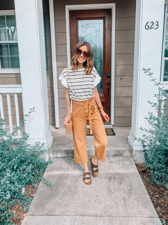 High waist paperbag pants // mustard colored pants and a striped flutter sleeve top // birkenstocks outfit // Vacation PACKING GUIDE - what I packed for a one week trip to San Antonio | Kansas City life, home, and style blogger Megan Wilson shares all of the items she packed for a one week spring break trip | What to pack for a one week spring break trip | lifeonshadylane.com | @shadylaneblog on IG