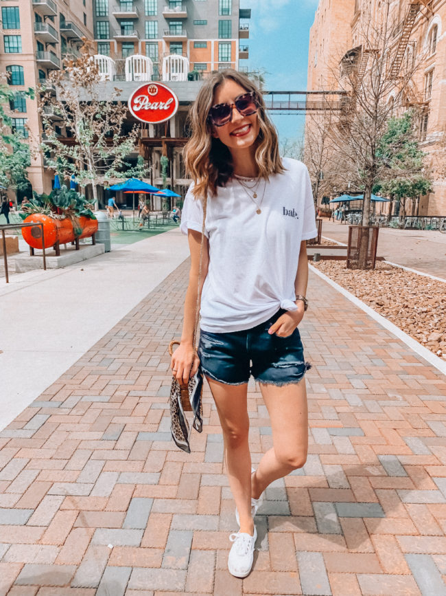 Black distressed shorts and a white knotted tee // Vacation PACKING GUIDE - what I packed for a one week trip to San Antonio | Kansas City life, home, and style blogger Megan Wilson shares all of the items she packed for a one week spring break trip | What to pack for a one week spring break trip | lifeonshadylane.com | @shadylaneblog on IG