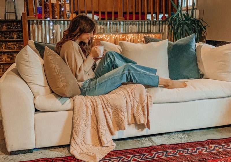 A vintage area rug in our living room || Slowly but surely decorating our new home! || Kansas City life, home, and style blogger Megan Wilson shares a peek at a new rug in her home's living room // concrete floors, vintage area rug, Christmas tree, fireplace