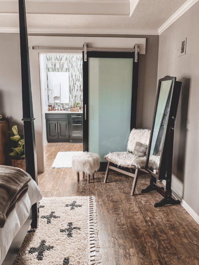 Flokati chair and stool, black and white area rug in master bedroom || Neutral master bedroom design, plus the plans we have to change things up! Kansas City life, home, and style blogger Megan Wilson shares her master bedroom design plans and inspiration