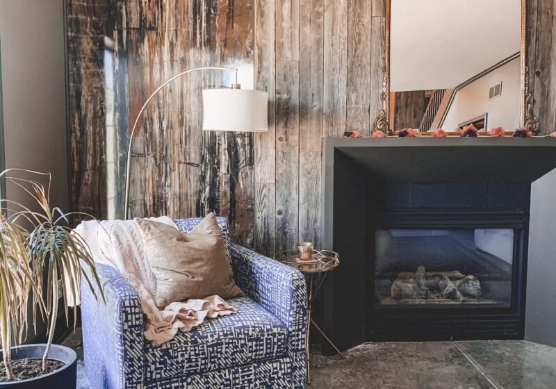 Gold Mirror over the Fireplace in the Living Room, white couch, wood planked fireplace wall || Kansas City life, home, and style blogger Megan Wilson shares a living room update