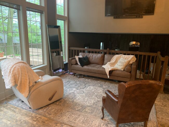 Home Tour: the BEFORE - click through to see our living room makeover!! Kansas City life, home, and style blogger Megan Wilson shares how she refreshed her living room with matching recliners, a turkish-inspired area rug, round coffee table, distressed wood side table, unique table lamp, and leather couch