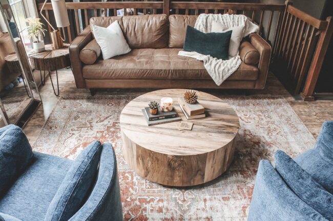 Home Tour: our living room makeover!! Kansas City life, home, and style blogger Megan Wilson shares how she refreshed her living room with matching recliners, a turkish-inspired area rug, round coffee table, distressed wood side table, unique table lamp, and leather couch