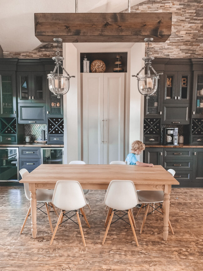 Dining room makeover - the "before" // Part 3 of my Home Tour Series! || Kansas City life, home, and style blogger Megan Wilson shares her dining area makeover with an area rug, wood table, white dining chairs, wood floors, and lots of cabinetry! 