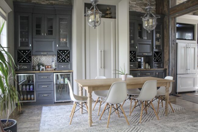 Light wood anthropologie dining table and white chairs, rug in dining room || Dining room inspiration || Kansas City life, home, and style blogger Megan Wilson shares a tour of her home, recently featured in Kansas City magazine