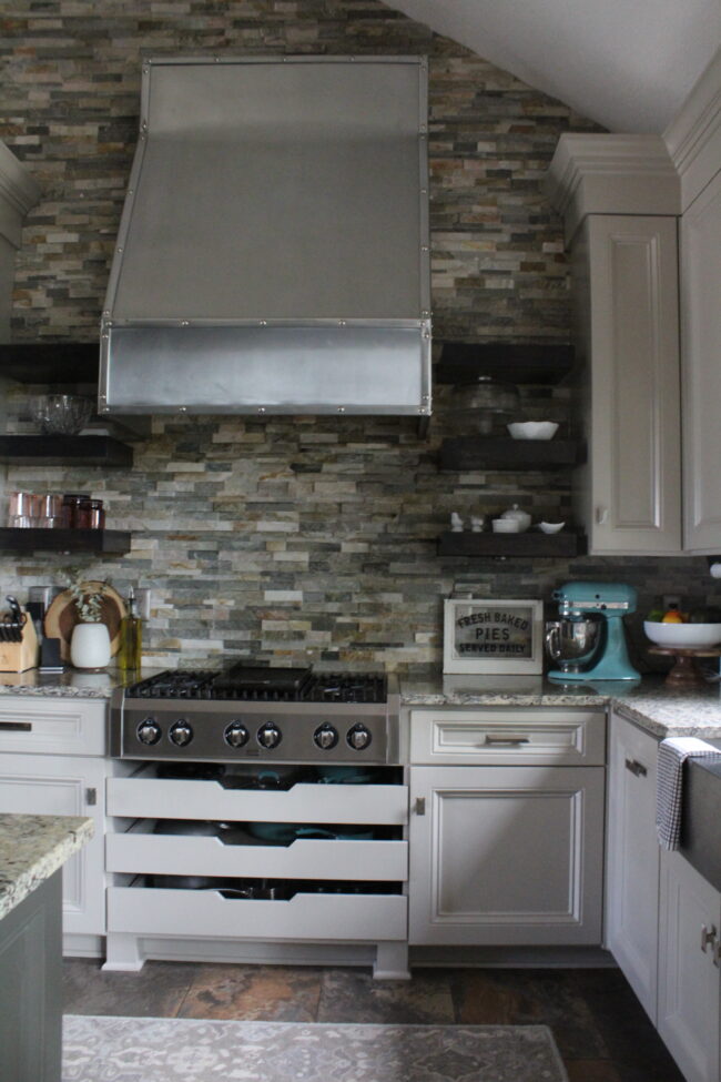 Rustic meets modern kitchen, stone backsplash, stainless steel range hood || Kitchen inspiration || Kansas City life, home, and style blogger Megan Wilson shares a tour of her home, recently featured in Kansas City magazine