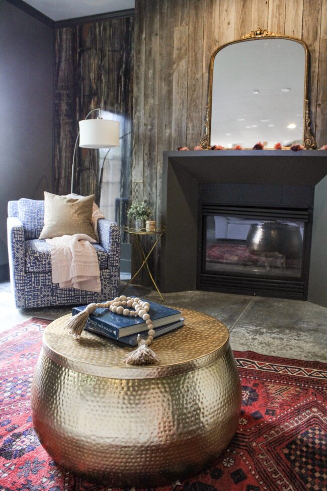 Vintage rug, gold coffee table, wood plank fireplace wall || Living Room || Kansas City life, home, and style blogger Megan Wilson shares a tour of her home, recently featured in Kansas City magazine