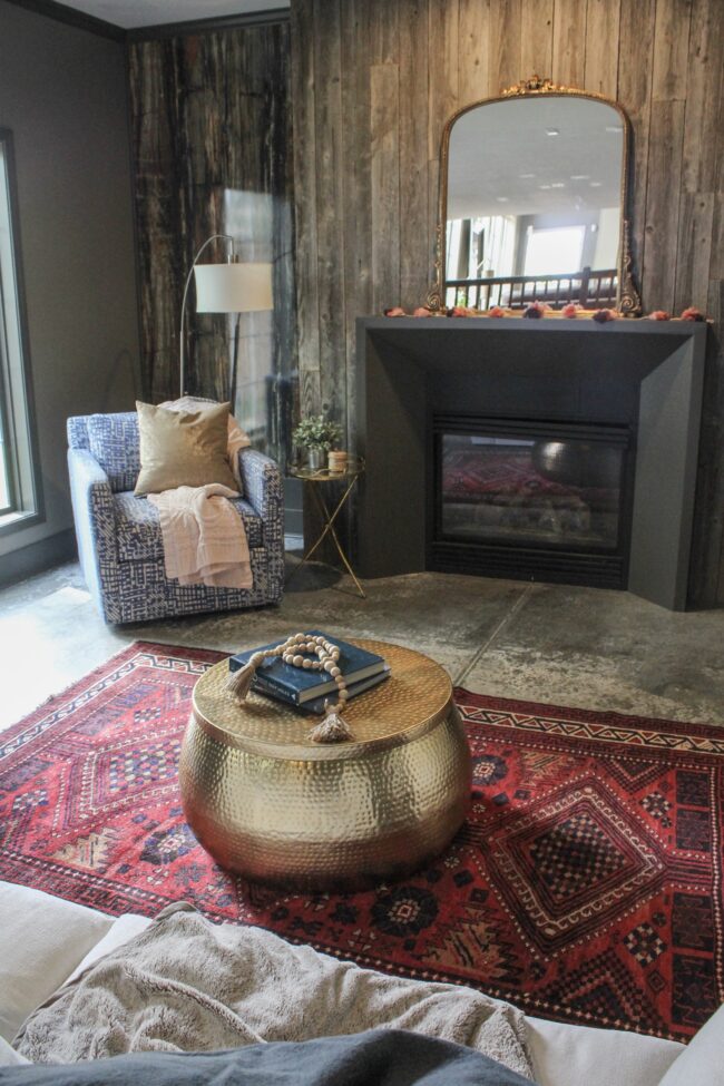 Vintage rug, gold coffee table, wood plank fireplace wall || Living Room || Kansas City life, home, and style blogger Megan Wilson shares a tour of her home, recently featured in Kansas City magazine