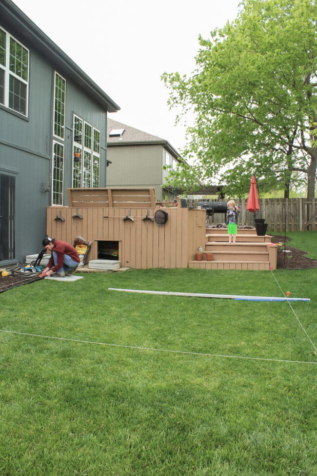 DIY patio with grass between pavers and a fire pit!