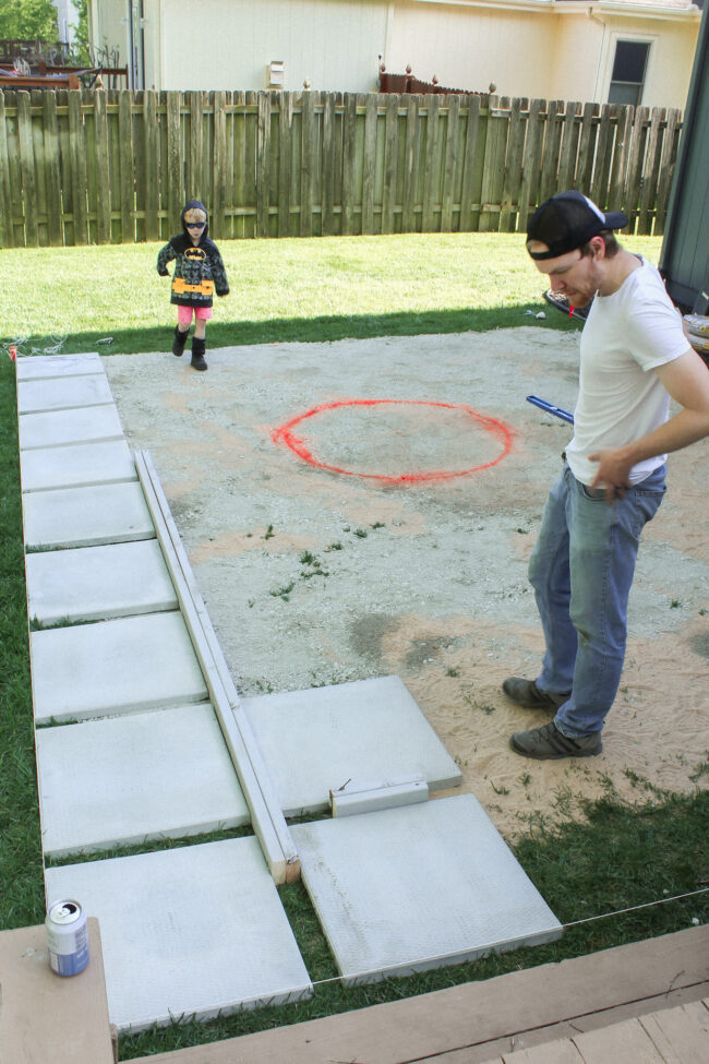 DIY patio with grass between pavers and a fire pit!