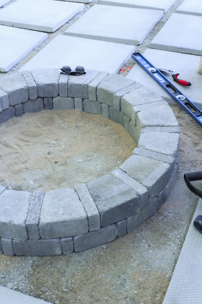 DIY paver patio and firepit - How to build your own patio and firepit! Patio with grass between pavers || Kansas City life, home, and style blogger Megan Wilson shares how to build your own patio and fire pit! 