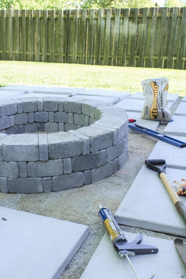 DIY paver patio and firepit - How to build your own patio and firepit! Patio with grass between pavers || Kansas City life, home, and style blogger Megan Wilson shares how to build your own patio and fire pit! 