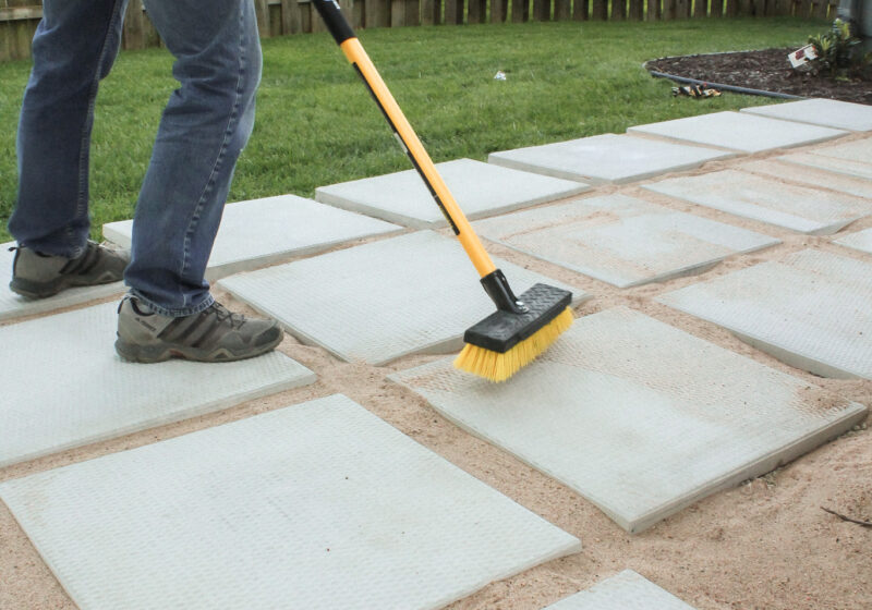 DIY patio with grass between pavers and fire pit