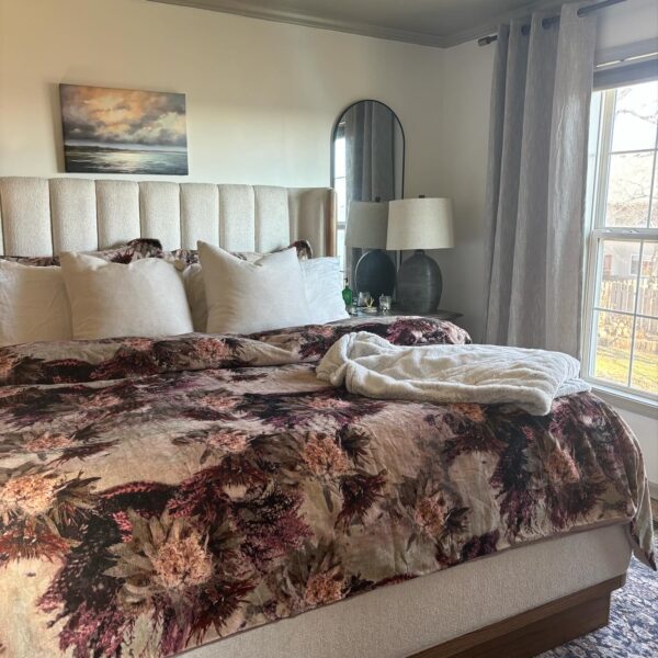 Primary bedroom makeover with upholstered king size bed, floral duvet, and organic modern touches